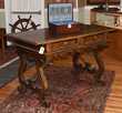Early Spanish walnut two-drawer trestle table, with iron stretcher, 55”L. x 34.5”H. x 29”W.