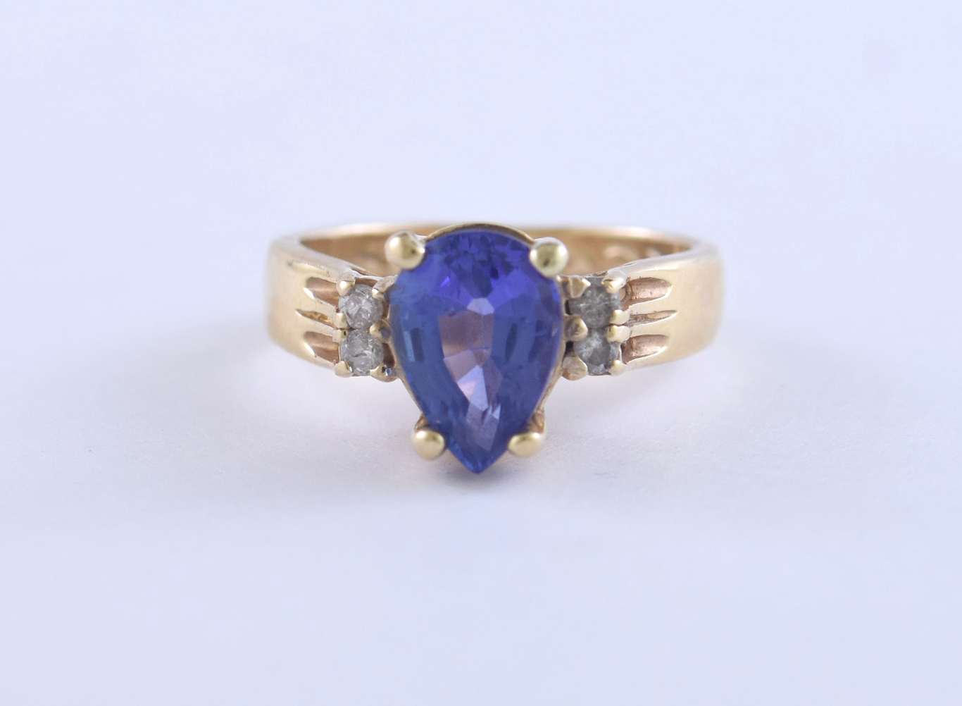 Pear shaped tanzanite and diamond ring set in 14k yellow gold